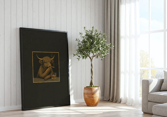 A modern interior displays the Highland Cow Cigar Club I poster with its charcoal black, antique gold and muted olive palette.