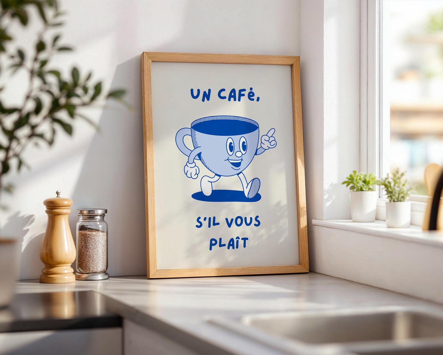 French café kitchen wall art with the phrase “Un Café S’il Vous Plaît” in blue lettering on a light background.