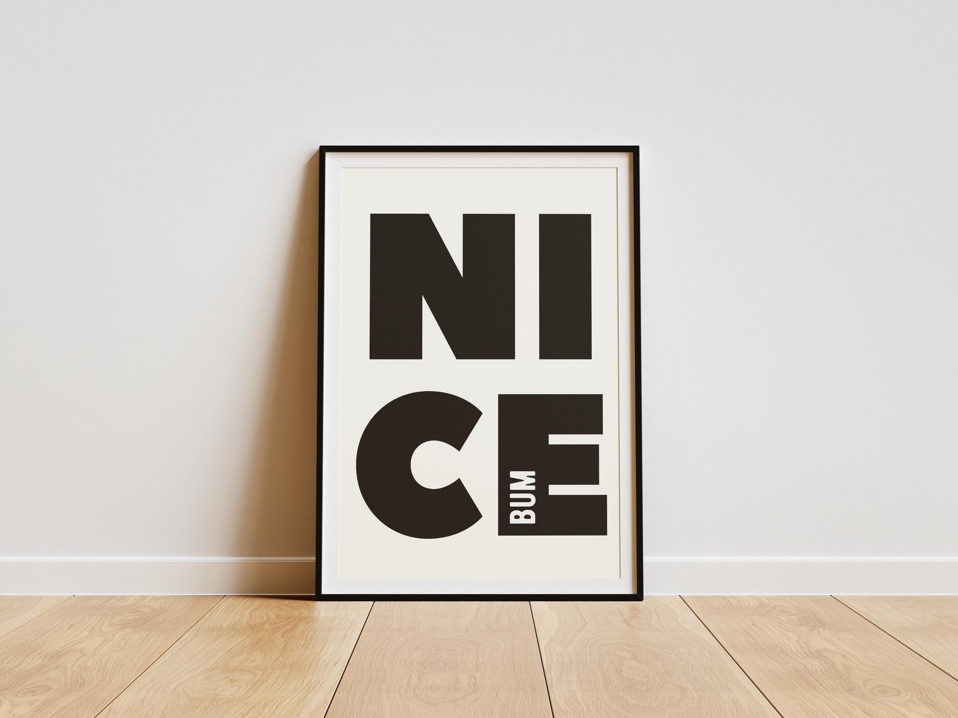 Nice bum typography print featuring bold black lettering, designed as cheeky modern bathroom art for toilets and guest bathrooms.