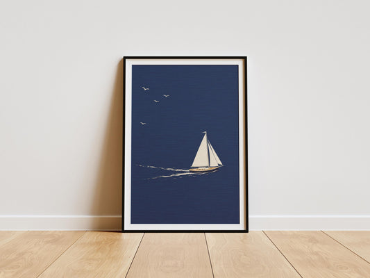 Minimalist sailboat wall art featuring a white yacht sailing across a deep navy blue ocean beneath a clear sky.