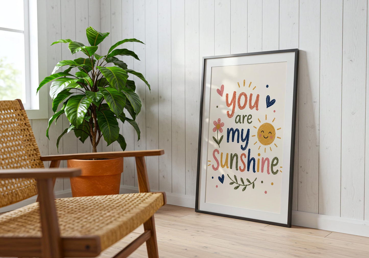 Colourful kids wall decor with You Are My Sunshine quote displayed beside a blue wooden cabinet in a modern home.