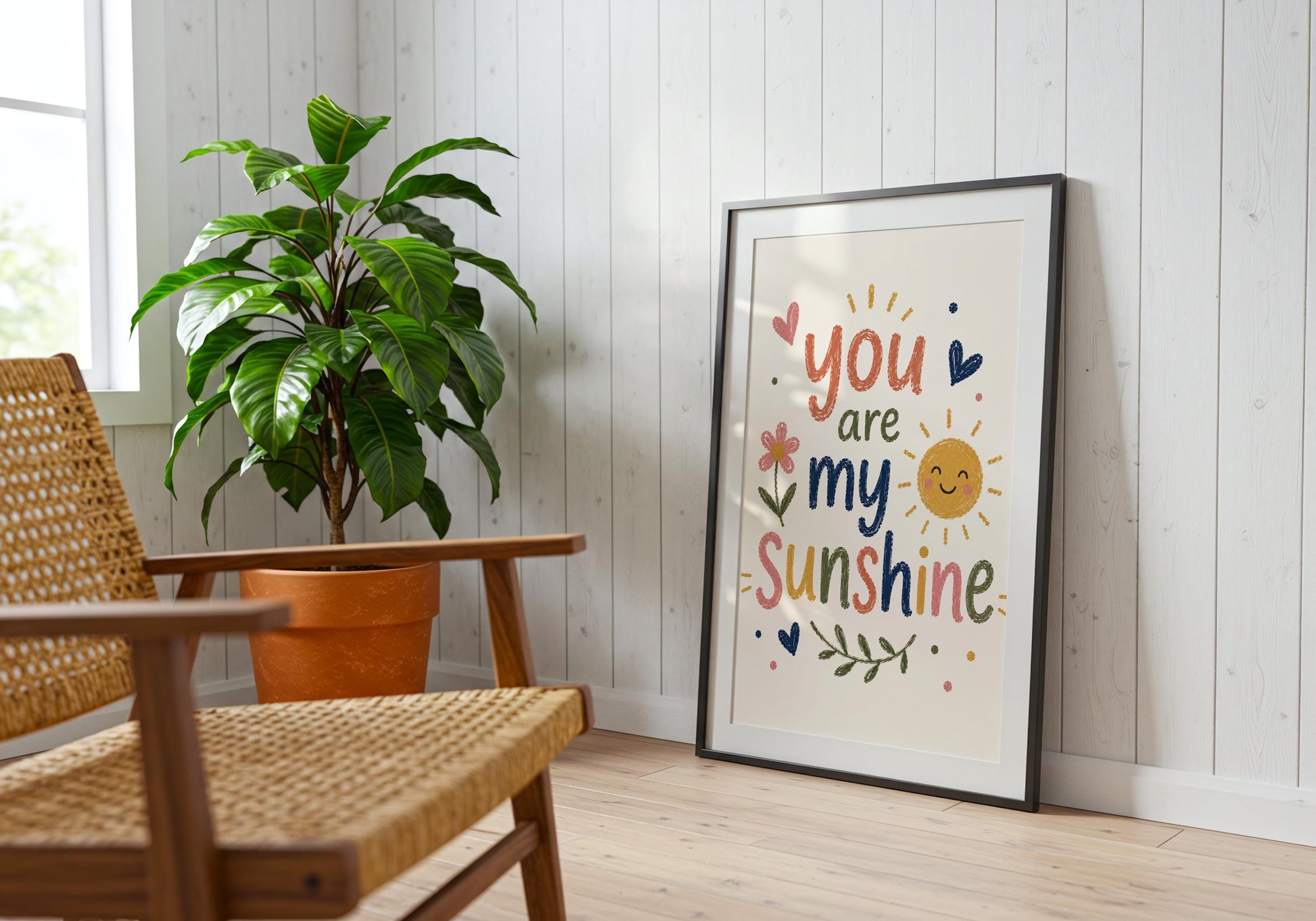 Colourful kids wall decor with You Are My Sunshine quote displayed beside a blue wooden cabinet in a modern home.