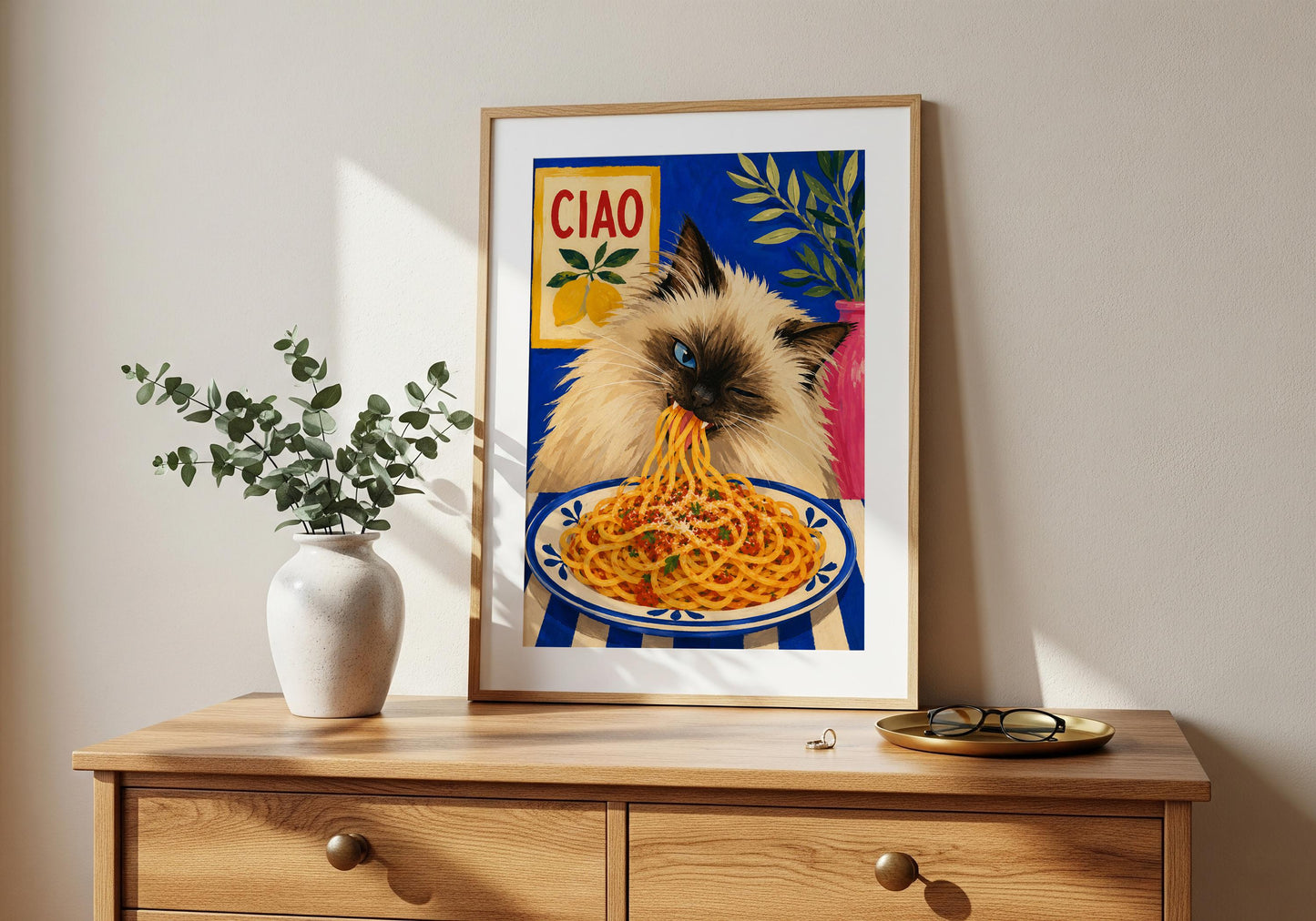 Dining room wall decor featuring a fluffy cat enjoying spaghetti.