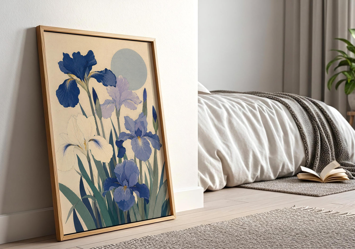 Framed blue botanical art print leaning against an elegant white panelled wall in a bright neutral room.