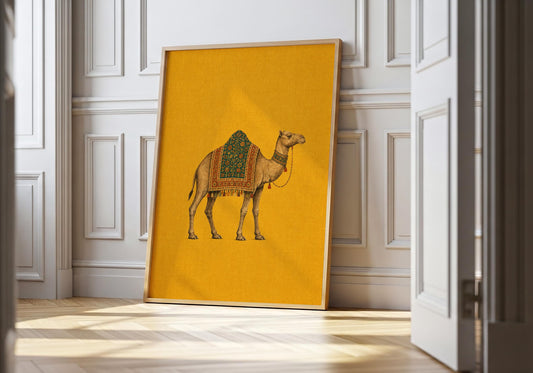 Camel wall art featuring an illustrated camel with an ornate teal and rust patterned saddle on a mustard yellow background.