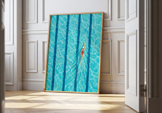 Aerial swimming pool wall art showing a lone swimmer moving through bright turquoise water between dark blue lane lines.