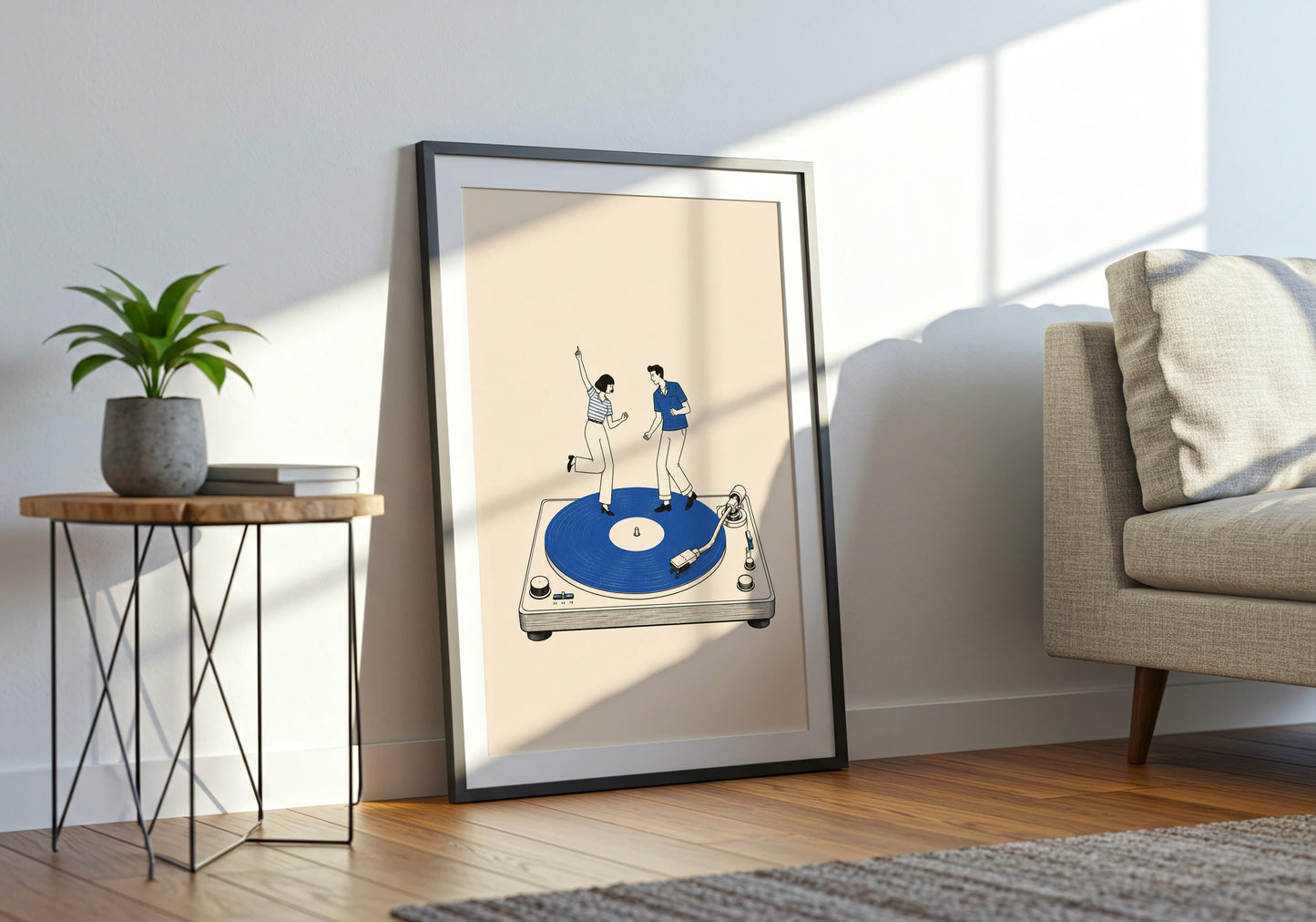 Minimalist blue wall art showing a dancing couple on an oversized record player against a neutral background.