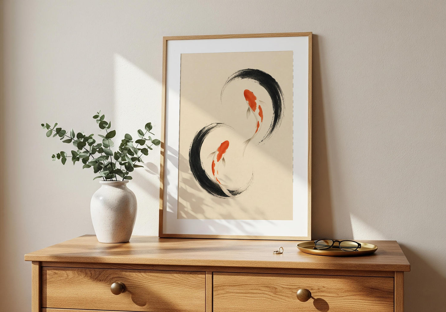 Japanese koi fish artwork displayed in a black frame beside a wooden bookshelf in a calm, plant-filled interior.
