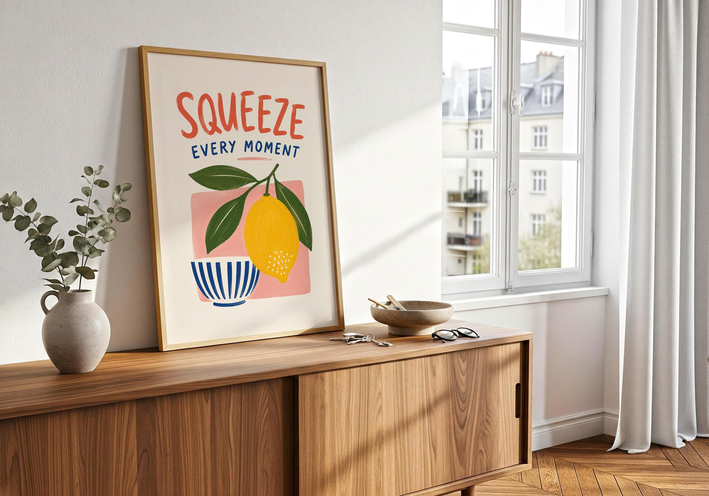 Kitchen quote art featuring the words Squeeze Every Moment with a bold lemon illustration and colourful painted shapes.