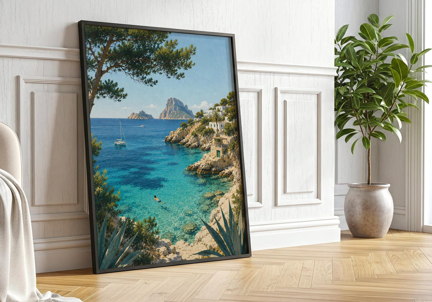 Framed Mediterranean seascape print displayed against a bright white panelled wall in a sunlit interior.