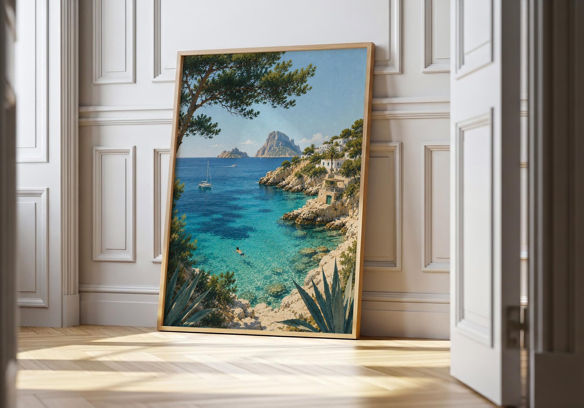 Ibiza-inspired Mediterranean coastal art print showing turquoise sea, rocky cliffs, white hillside buildings and sailing boats.