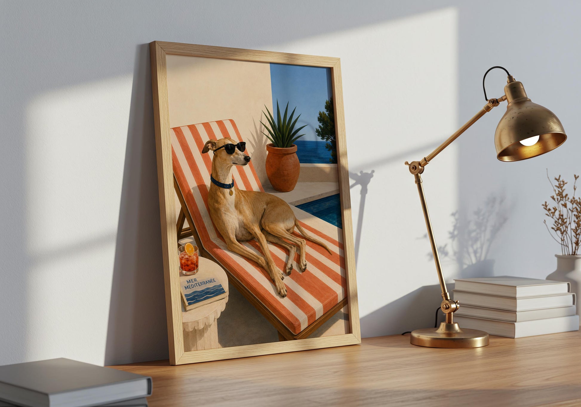 Large framed greyhound print displayed in a bright interior, featuring a glamorous poolside dog and Mediterranean coastal scenery.
