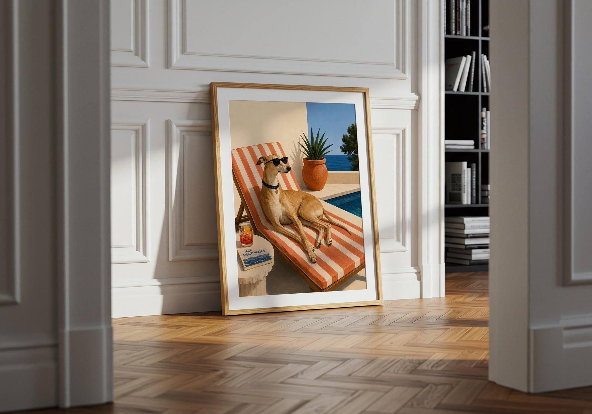 Framed Mediterranean dog print featuring a greyhound on a striped sun lounger beside a terracotta plant pot and swimming pool.