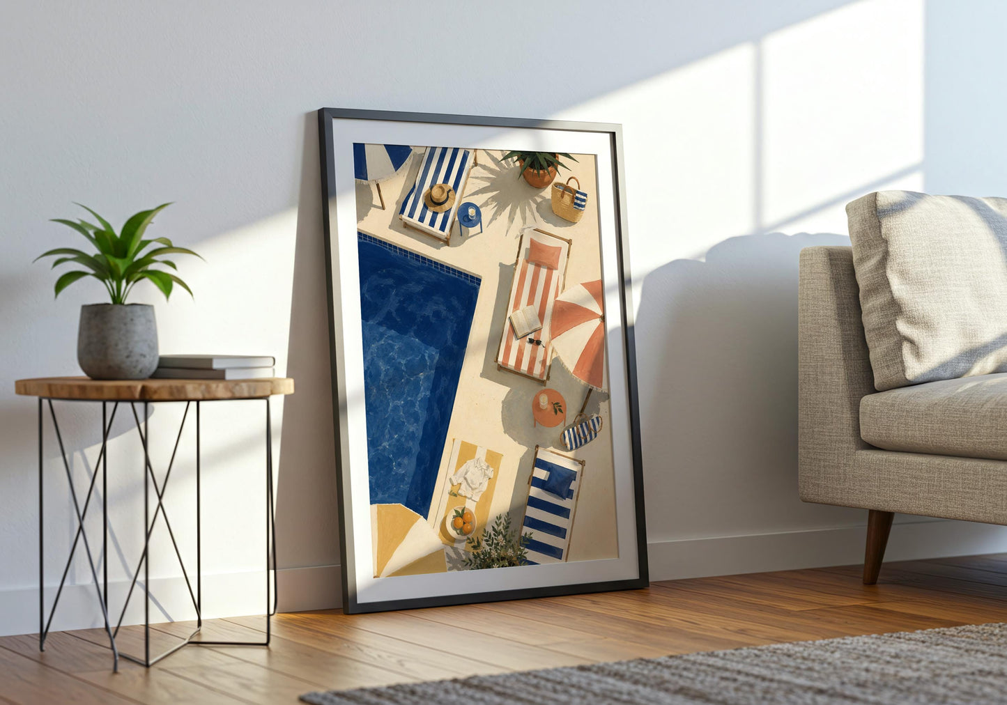 Framed coastal pool print displayed in a bright interior, featuring deep blue water and warm retro summer colours.