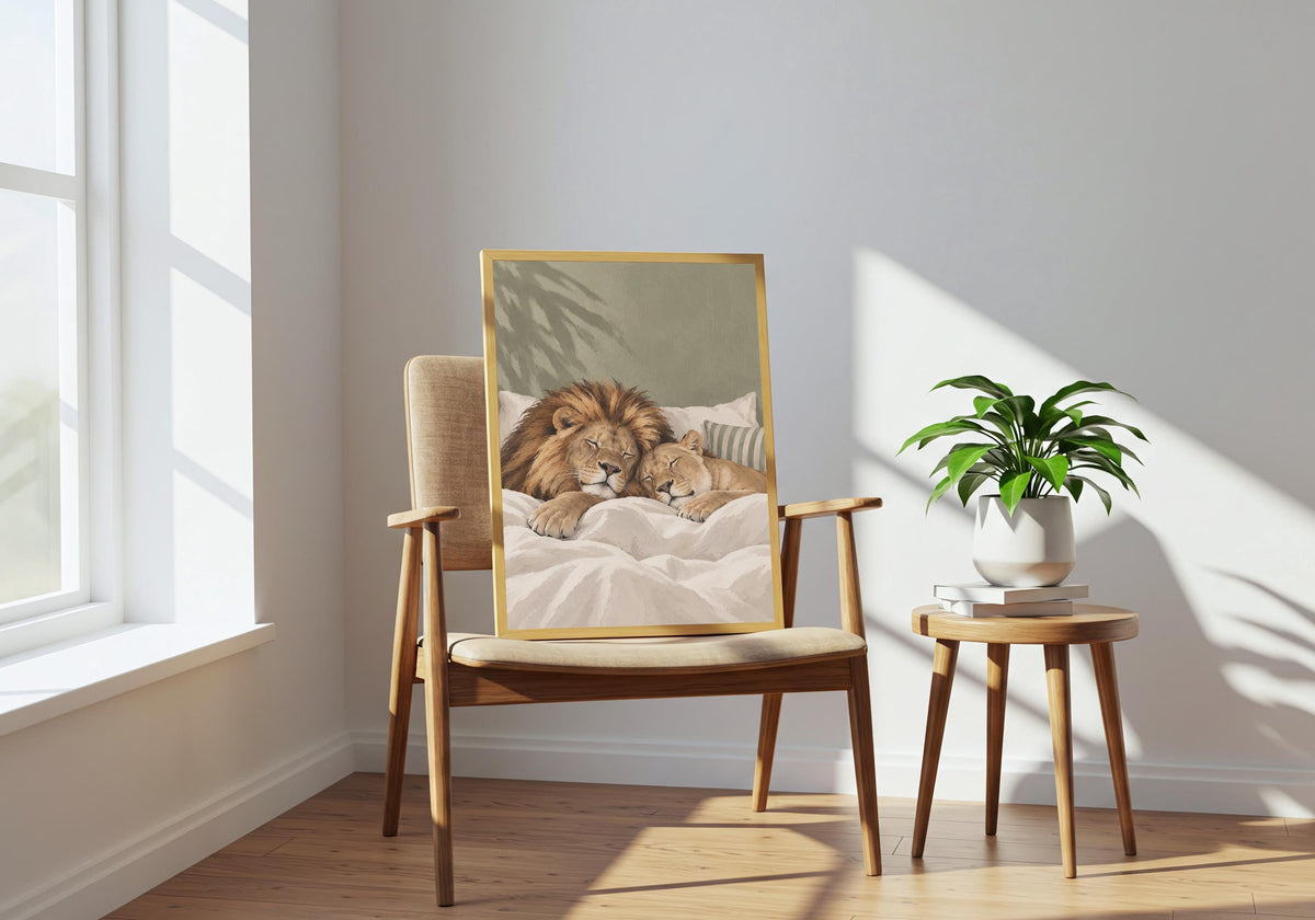 Room mockup of the Sleeping Lions print featuring a lion and cub enjoying a peaceful bedtime cuddle, hung above a modern chair in a bright interior.