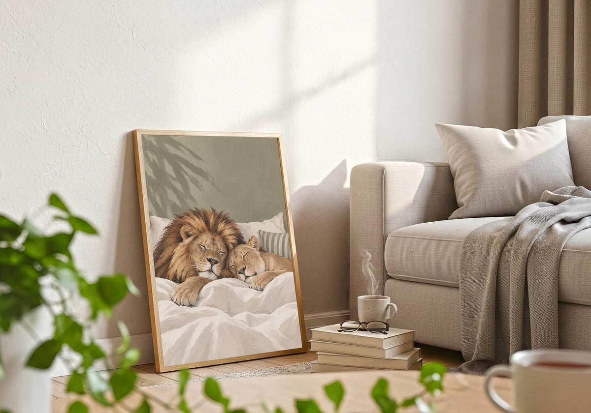 Interior view of Sleeping Lions wall art with a lion and cub enjoying a peaceful bedtime cuddle, hung in a white frame in a bright modern room.