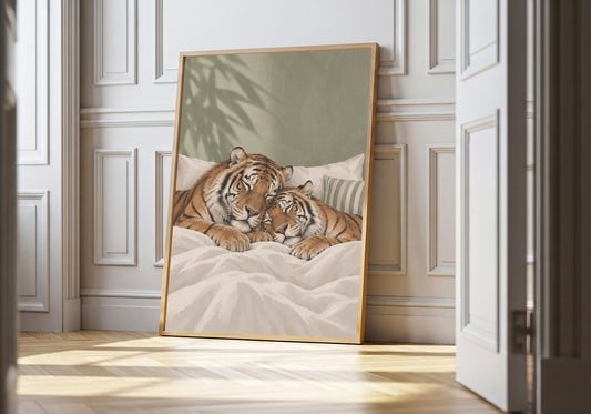 Sleeping Tigers sleeping couple print featuring two striped tigers curled up together beneath crisp white bedding, leaning in a light natural-wood hero frame against bright white panelling.