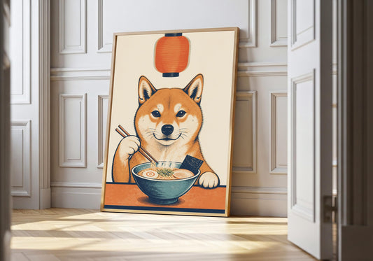 Funny Shiba Inu print of a dog using chopsticks over a ramen bowl, leaning in a light natural-wood frame against white panelling.