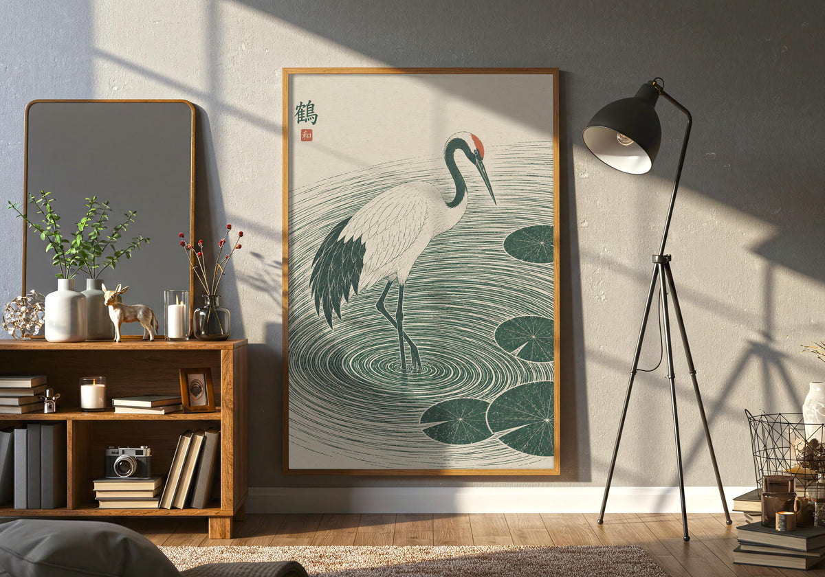 Room view of Crane Lily Pond as green bird print, shown in a dark frame in a wide living-room view.