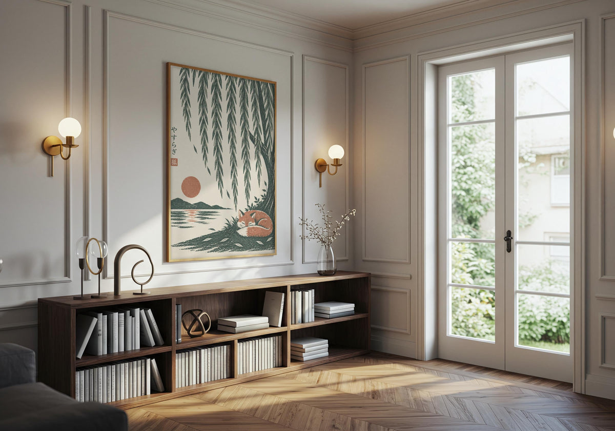 Cottagecore print showing a rust-coloured fox curled asleep beneath cascading willow branches and a low sun, hung in a dark frame above a low media console.