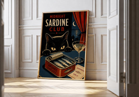Midnight Sardine Club black cat and sardine print leaning in a light natural-wood frame in a bright panelled room.