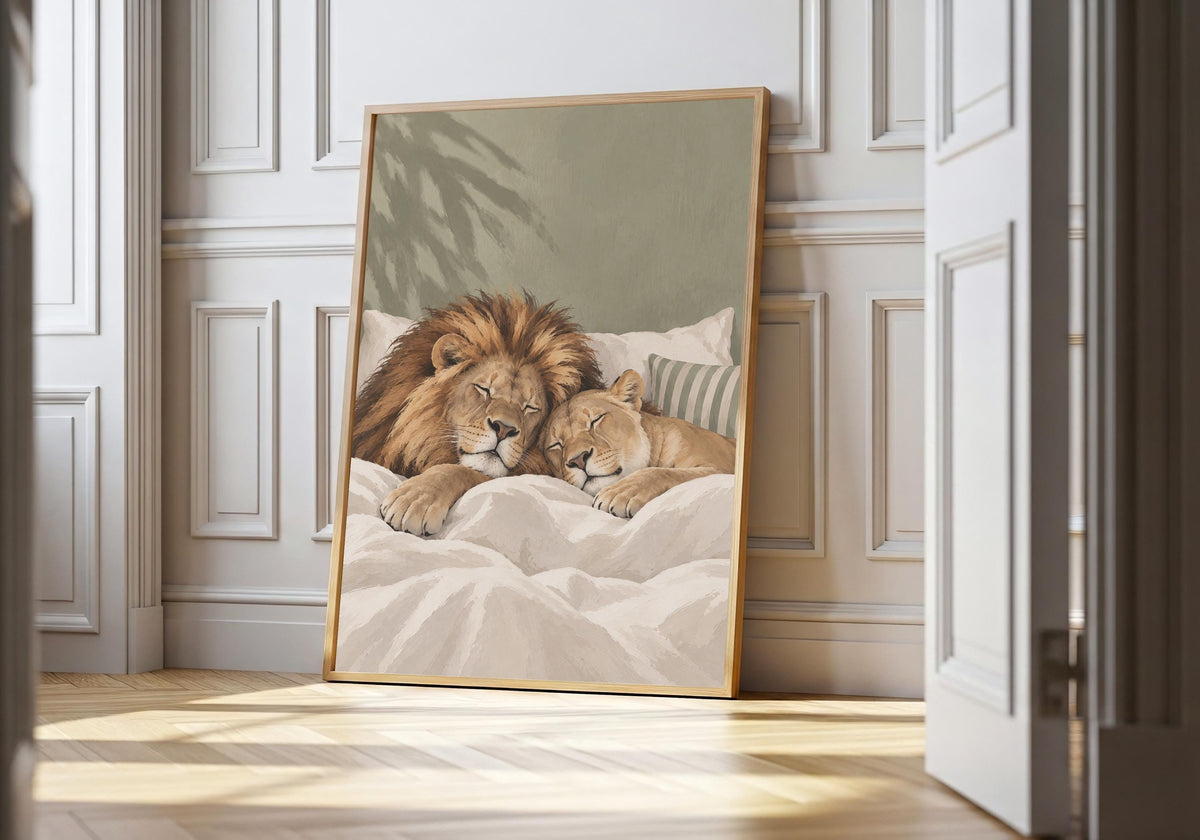 Sleeping Lions sleeping lion print featuring a lion and cub enjoying a peaceful bedtime cuddle, leaning in a light natural-wood hero frame against bright white panelling.
