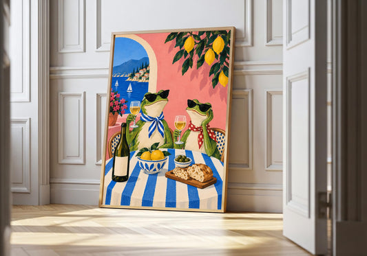 Riviera Frogs Lunch appears in the light-wood hero scene, clearly showing two stylish frogs sharing lunch and wine by a bright blue coast.