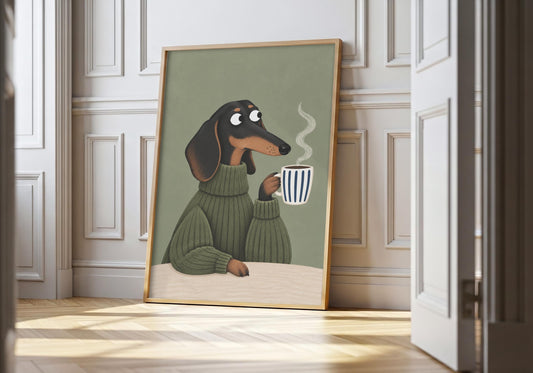 Dachshund print showing a black-and-tan dachshund in a sage jumper holding a steaming striped mug, leaning in a light natural-wood hero frame against white panelling.