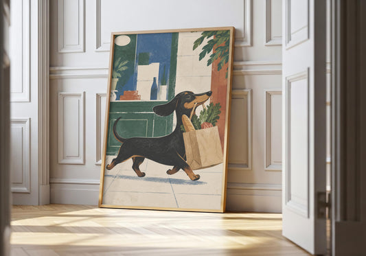 Dachshund print showing a black dachshund carrying a paper bag of leafy groceries past a green deli, leaning in a light natural-wood hero frame against white panelling.