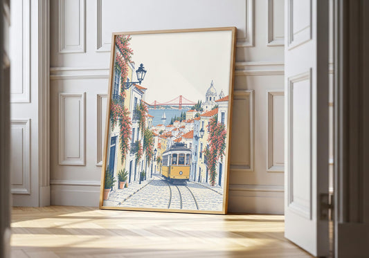 Lisbon tram print showing a yellow Lisbon tram on a colourful cobbled street with water in the distance, leaning in a light natural-wood hero frame against white panelling.