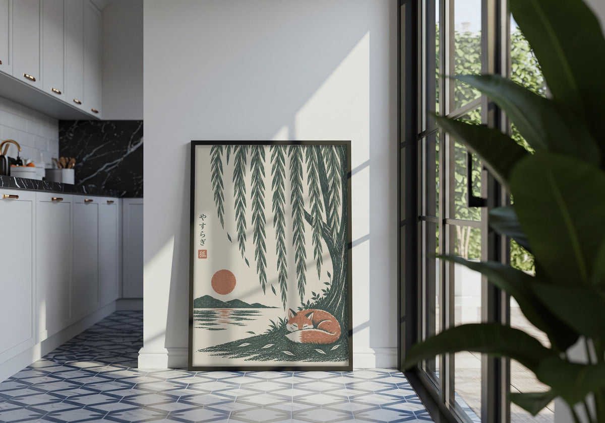 Portrait nature wall poster featuring a rust-coloured fox curled asleep beneath cascading willow branches and a low sun, displayed in a black frame in a tiled interior.