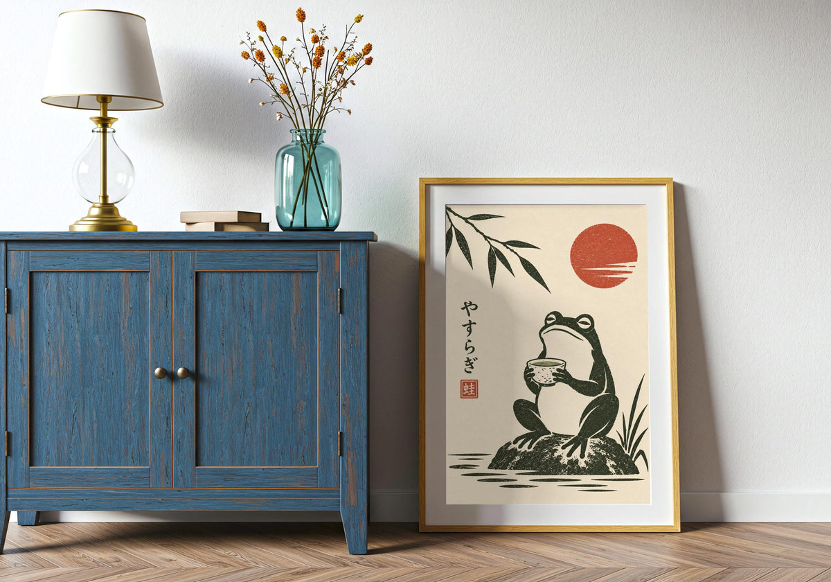 The visible artwork features a seated frog calmly holding a tea bowl beside bamboo and a red sun within a believable portrait frame.