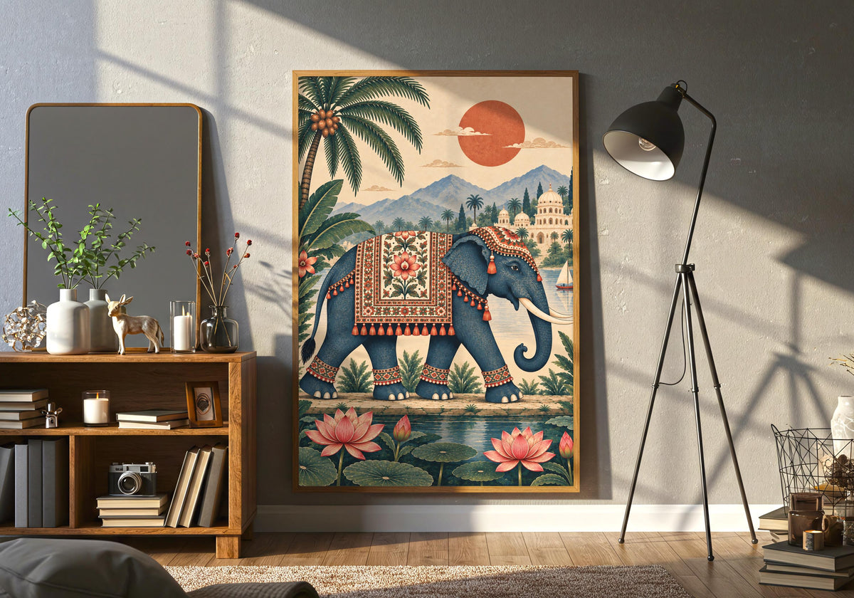 A closer lifestyle view beside a neutral sofa highlights a decorated Indian elephant walking beside pink lotus flowers with a palace, palm trees, mountains and a coral sun behind as india travel decor.