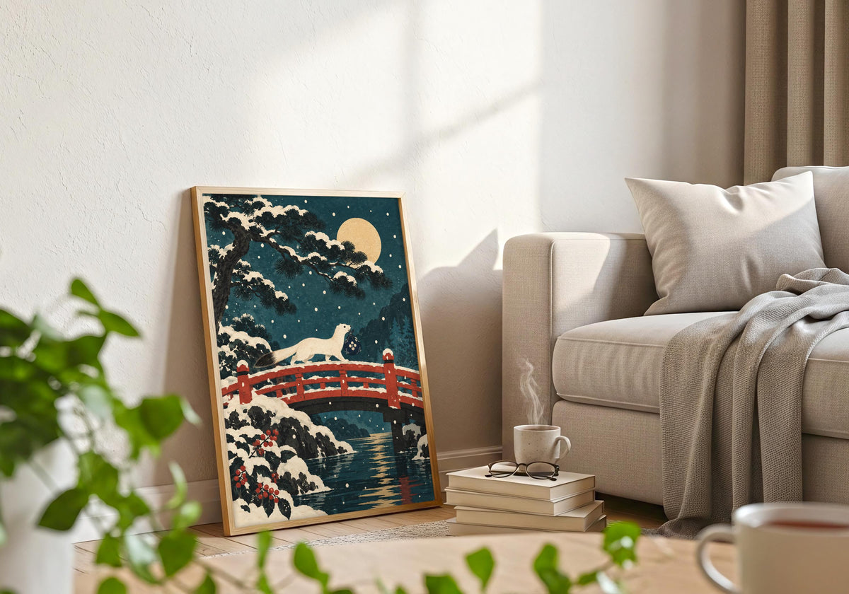 A light-wood frame beside a pale sofa holds the illustration of the stoat crossing the bridge.
