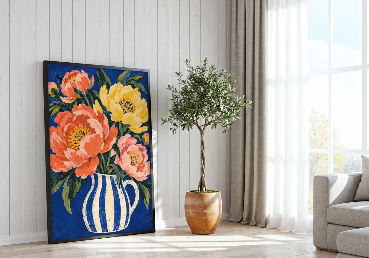 Placed on the floor beside a bright window and potted tree, the artwork shows pink and yellow flowers.
