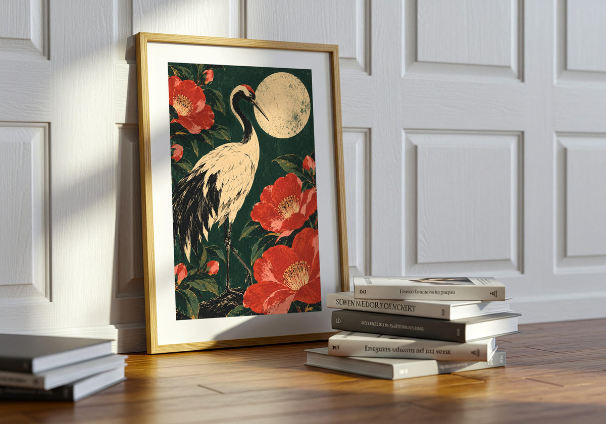 Here, the print of the crane-and-camellia picture sits on a table beside stacked books.