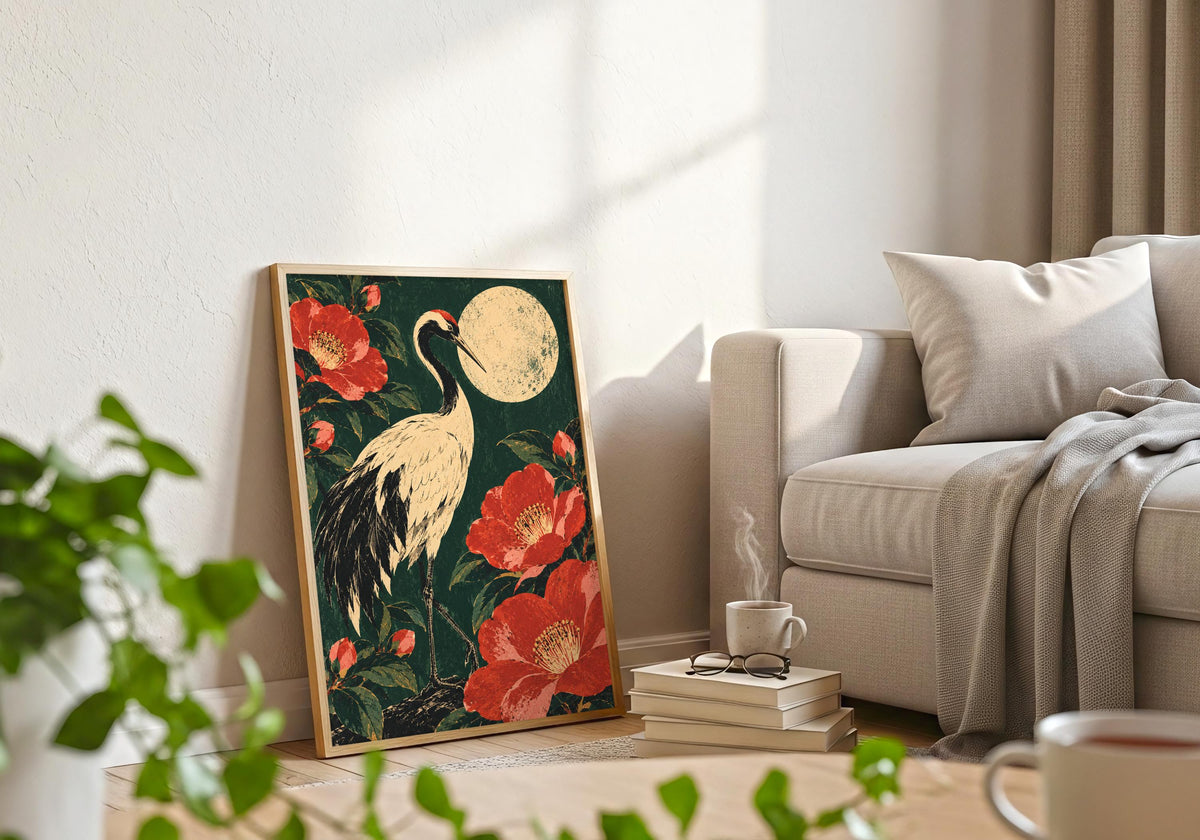 The styling pairs the Japanese-inspired floral bird scene with a frame beside a pale sofa, books and foreground greenery.