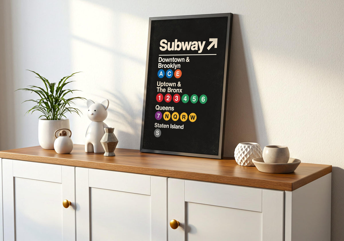 Greenery and furniture surround the framed artwork depicting bold cream New York subway directions and coloured route circles on black.