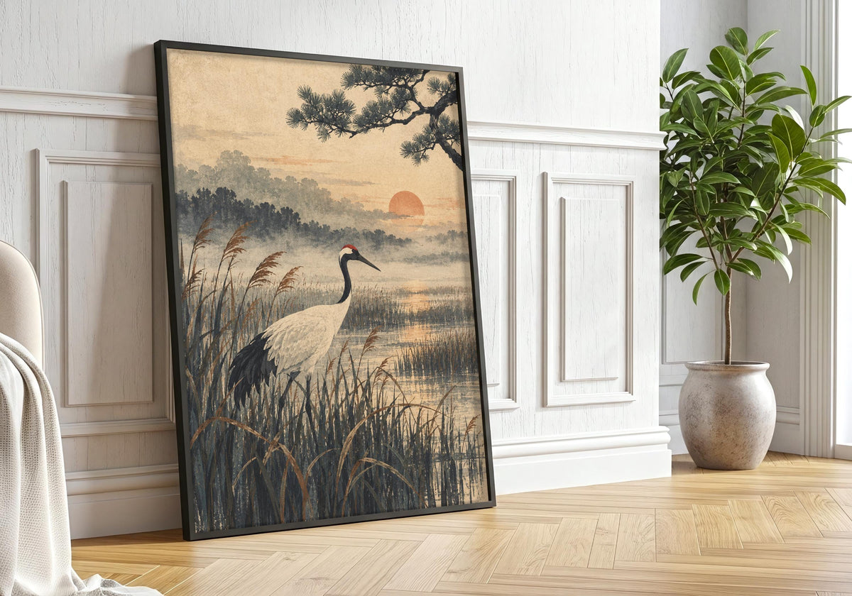 Black-framed bird artwork is styled with greenery in a softly lit room.