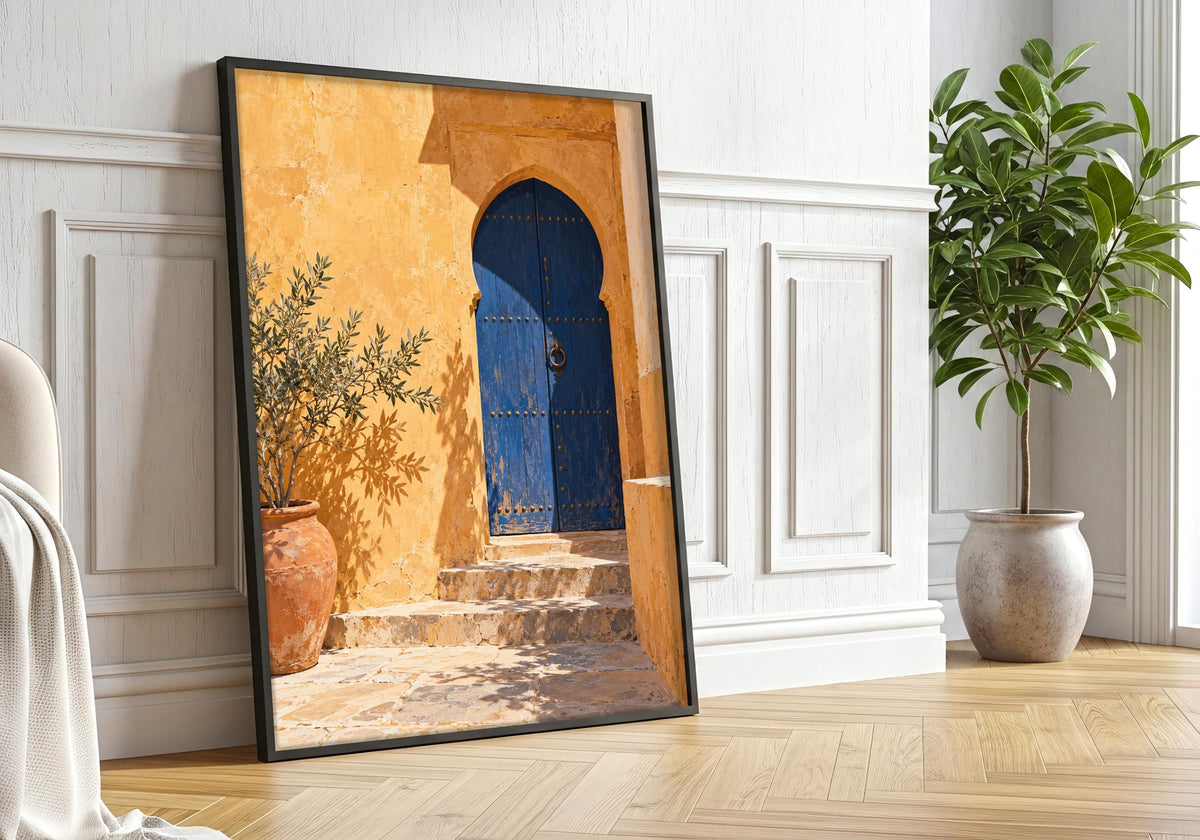 Black-framed courtyard art displayed near greenery in a calm room.