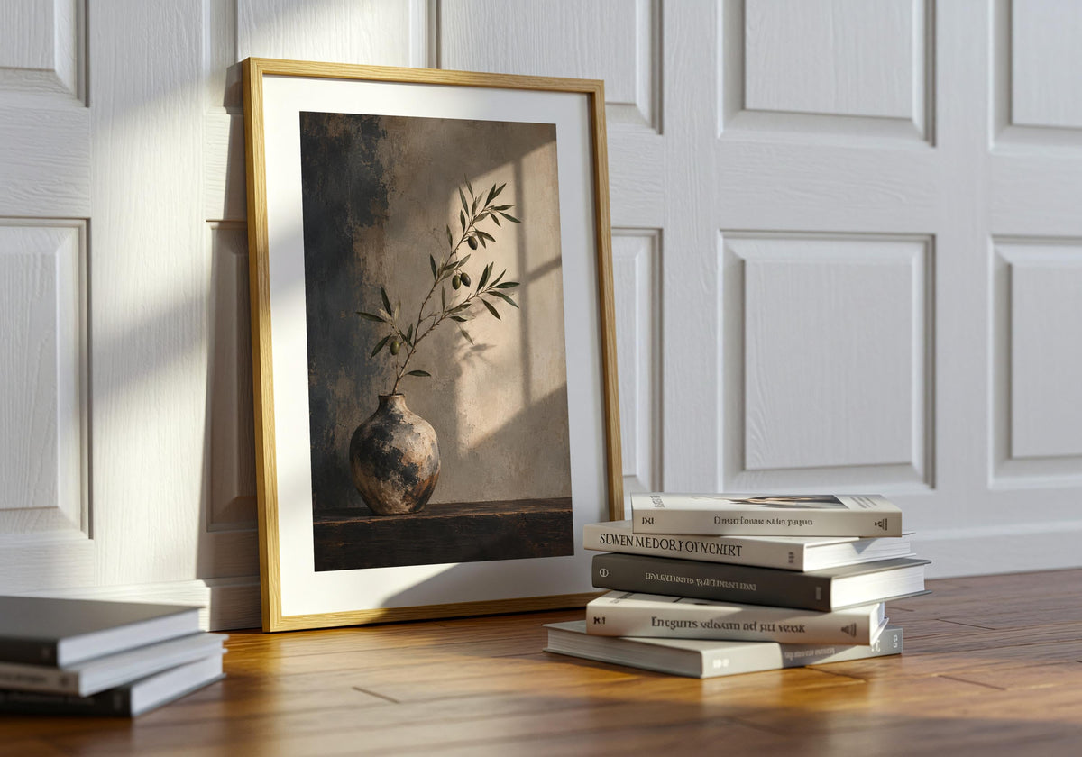 A potted plant sits near the framed olive still life in this interior scene.