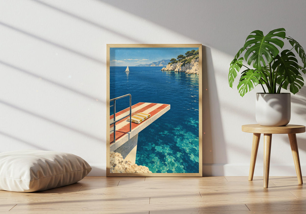 A potted plant sits near the framed blue coast print.