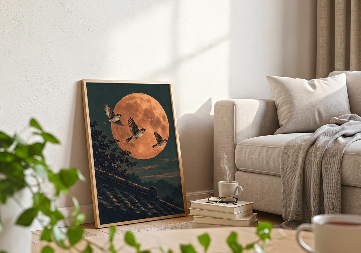 A light-wood frame beside a pale sofa holds the illustration of the three flying sparrows.