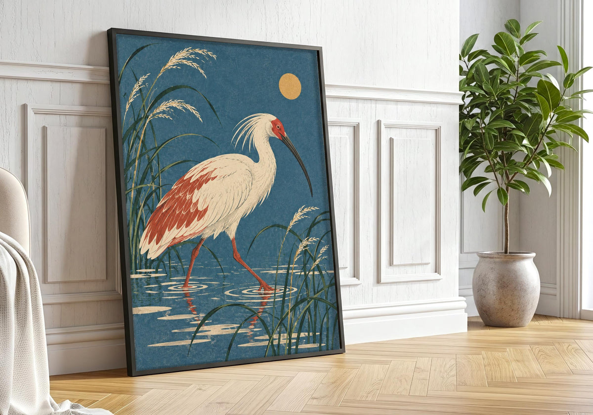 Black framing beside a leafy potted tree surrounds the picture of the long-legged wetland scene.