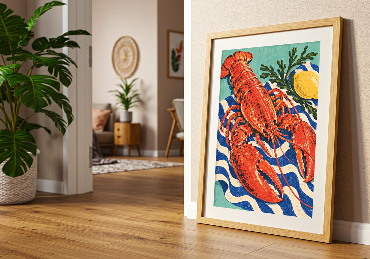 The styling pairs the lemon-and-lobster composition with a frame on a wooden floor beside green houseplants.