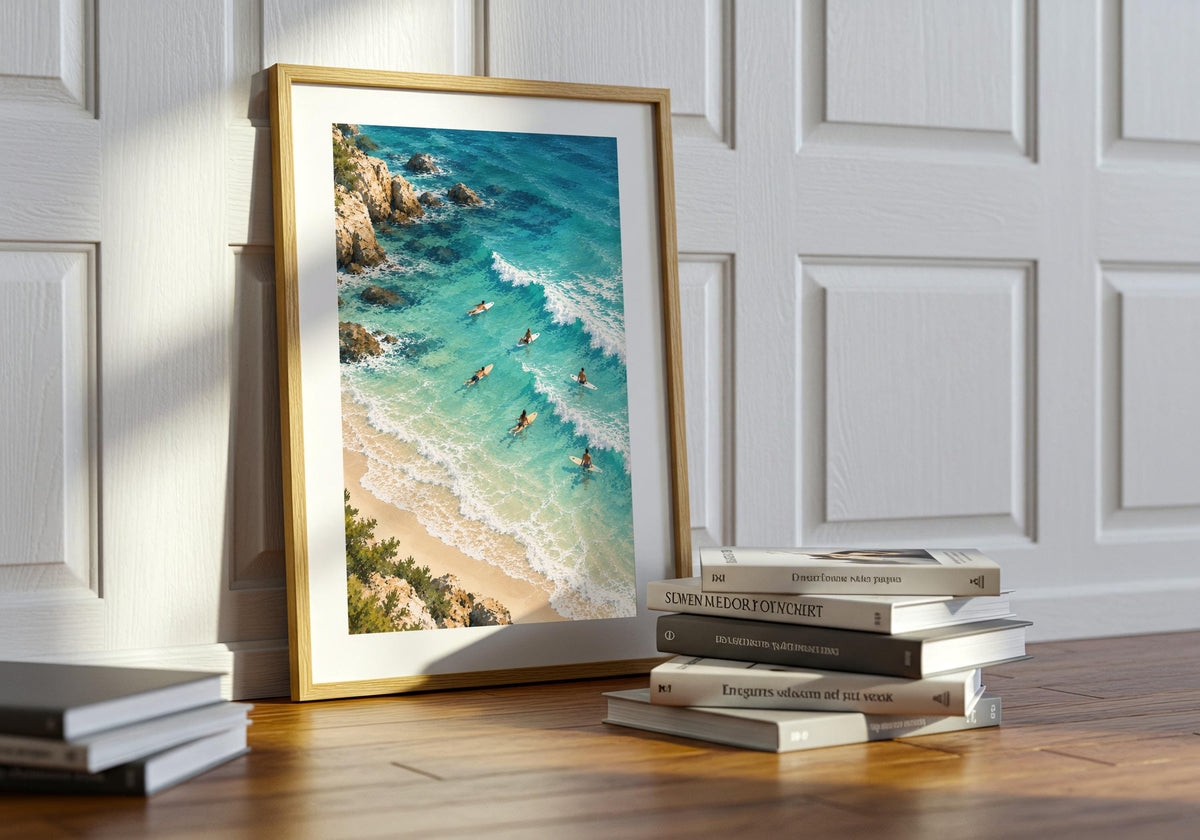 Here, the print of the broad coastal landscape sits on a table beside stacked books.