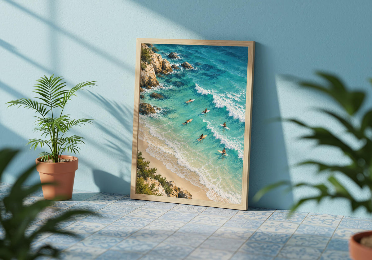 See the surfers’ small shapes below in the framed artwork against a blue wall with leafy shadows.