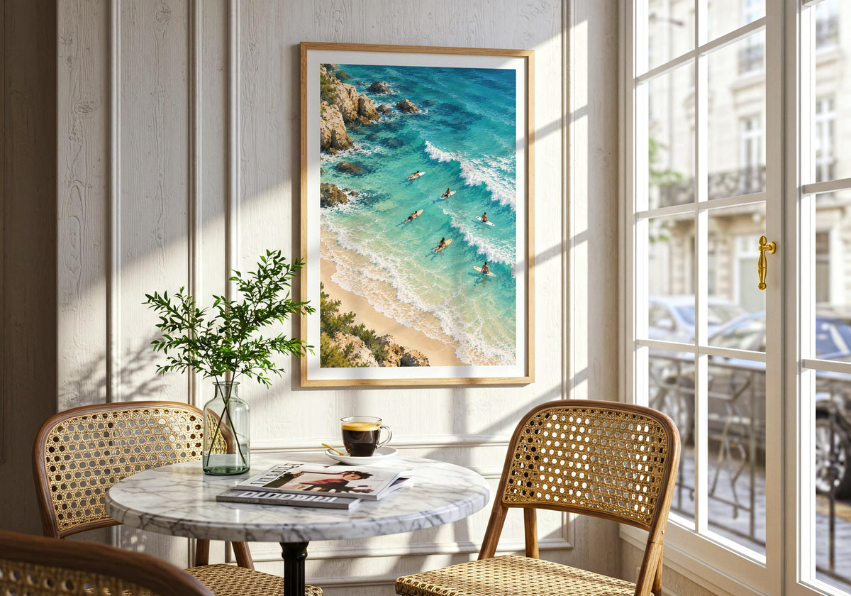 An interior view displays the overhead coast illustration on the wall beside a round marble dining table.