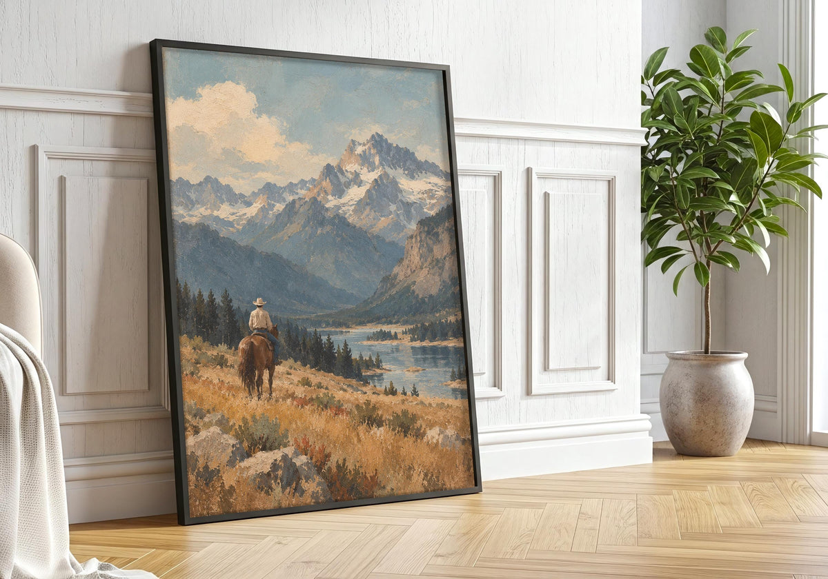 Against the black frame greenery interior, the artwork depicts a solitary cowboy overlooking a broad mountain valley in a vintage western composition and centres the artwork rather than the styling.